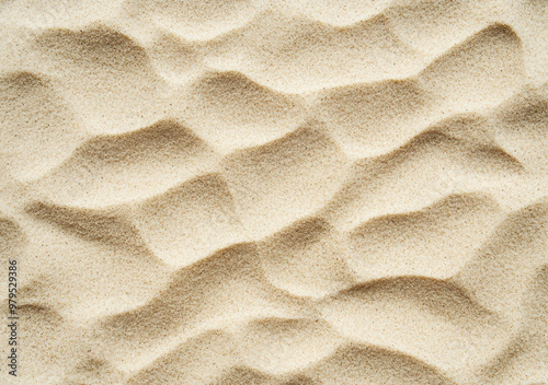 Aerial view of wind creating wavy pattern on sand dune background