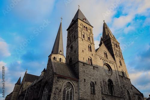 Historic church towers rise under a dramatic sky in Ghent, Belgium during late afternoon lighting