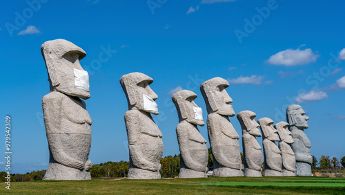 View of award-winning architecture and serene stone statues wearing masks at Makomanai Takino Cemetery, Sapporo, Japan. photo