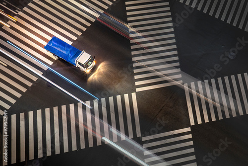 View of bustling traffic junction with light streaks and a speeding truck at night, Yurakucho, Tokyo, Japan. photo