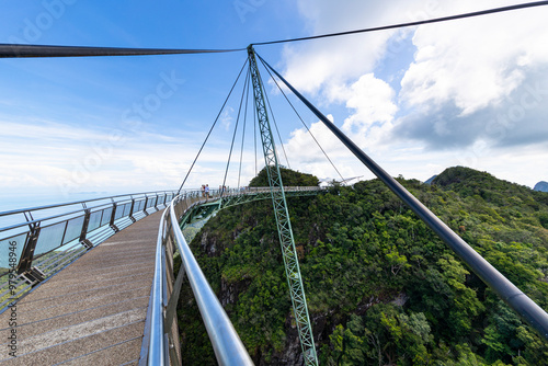 View of sky bridge over lush jungle and majestic mountains, Kuah, Malaysia. photo