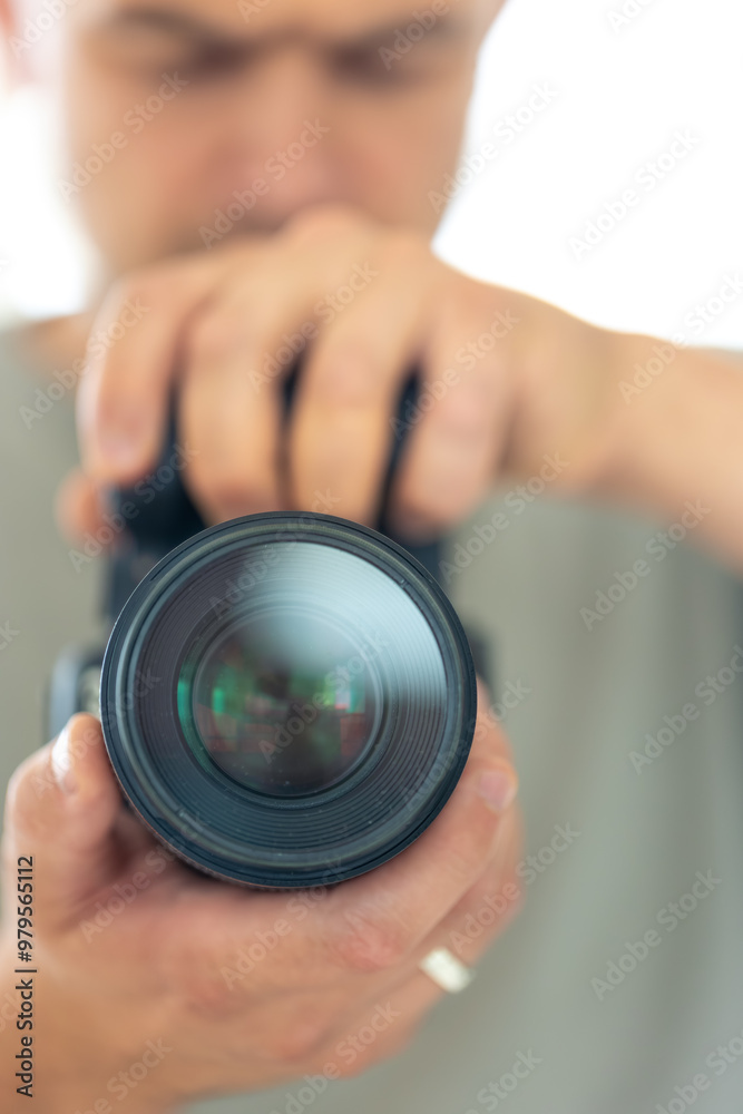 A man takes a photo of himself in the mirror with a camera. Close-up photo. A man takes a photo of himself in the mirror with a camera. Close-up photo.