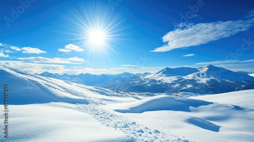 Panoramic view of snow-covered mountains with a clear blue sky and bright winter sunshine.