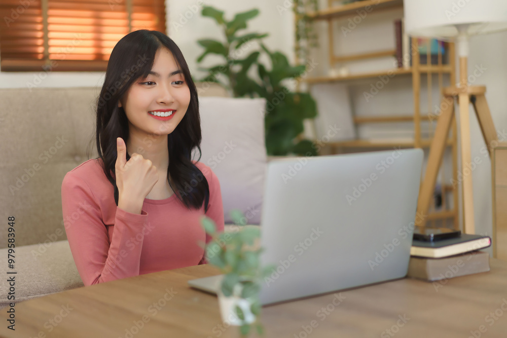 Young businesswoman use laptop to meeting on video call and showing thumb up gesture with colleague Young businesswoman use laptop to meeting on video call and showing thumb up gesture with colleague