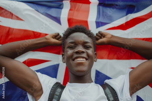 Vibrant smile of nigerian teen boy holding uk flag. UK Cities Struggle with Surge in Immigrant Population.  Allegory of youthful resilience and determination. photo