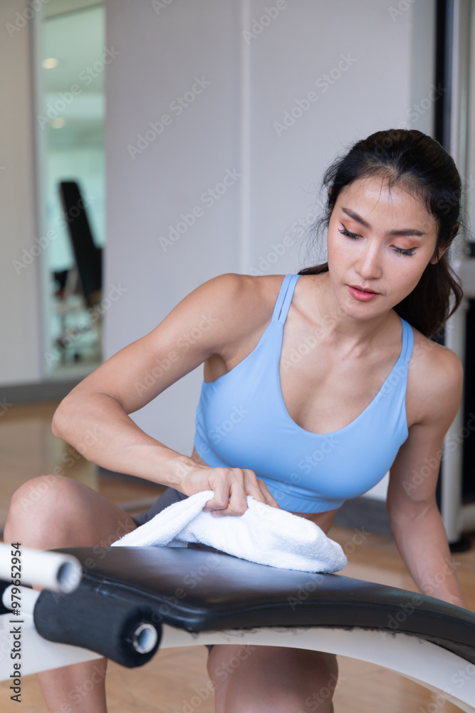 Active Lifestyle of Fitness Woman Disinfecting Gym Bench Equipment After an Intense Workout Session Active Lifestyle of Fitness Woman Disinfecting Gym Bench Equipment After an Intense Workout Session