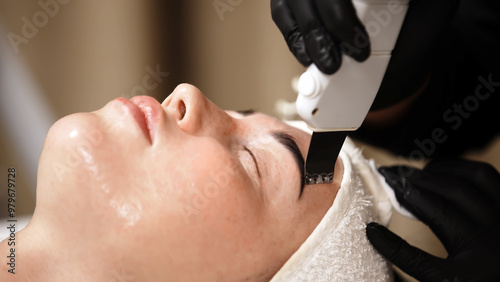 Close-up of ultrasonic facial cleansing in action, focusing on skin peeling. The process highlights the advanced technology used for deep exfoliation and rejuvenation in skincare.