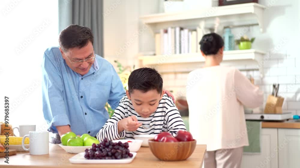 Happy Asian family with farther, mother, and son are enjoy eating a breakfast together in kitchen, Happy Asian family with farther, mother, and son are enjoy eating a breakfast together in kitchen,