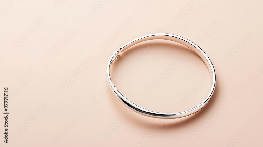 Delicate bracelet with open cuff design, minimalist silver jewelry on a neutral beige background Delicate bracelet with open cuff design, minimalist silver jewelry on a neutral beige background