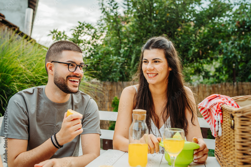 Group of three friends or family having picnic in backyard or garden Group of three friends or family having picnic in backyard or garden