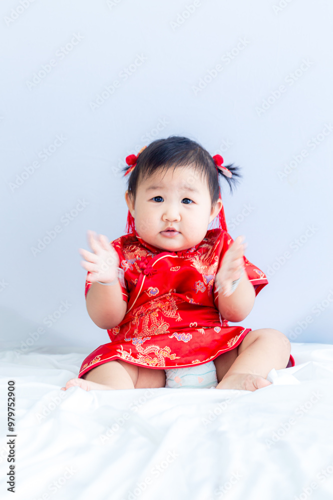 Girl in Chinese New Year costume,Happy Little asian girl in chinese traditional dress laughing and smiling.