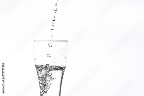 Pouring water into a glass on a white background. Close-up image,Glass of drinking water isolated on white background  photo