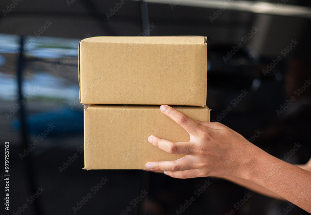 Parcel box and human hand,Customer signing document and receiving the parcel from delivery man,Delivery woman delivering box to the man Parcel box and human hand,Customer signing document and receiving the parcel from delivery man,Delivery woman delivering box to the man