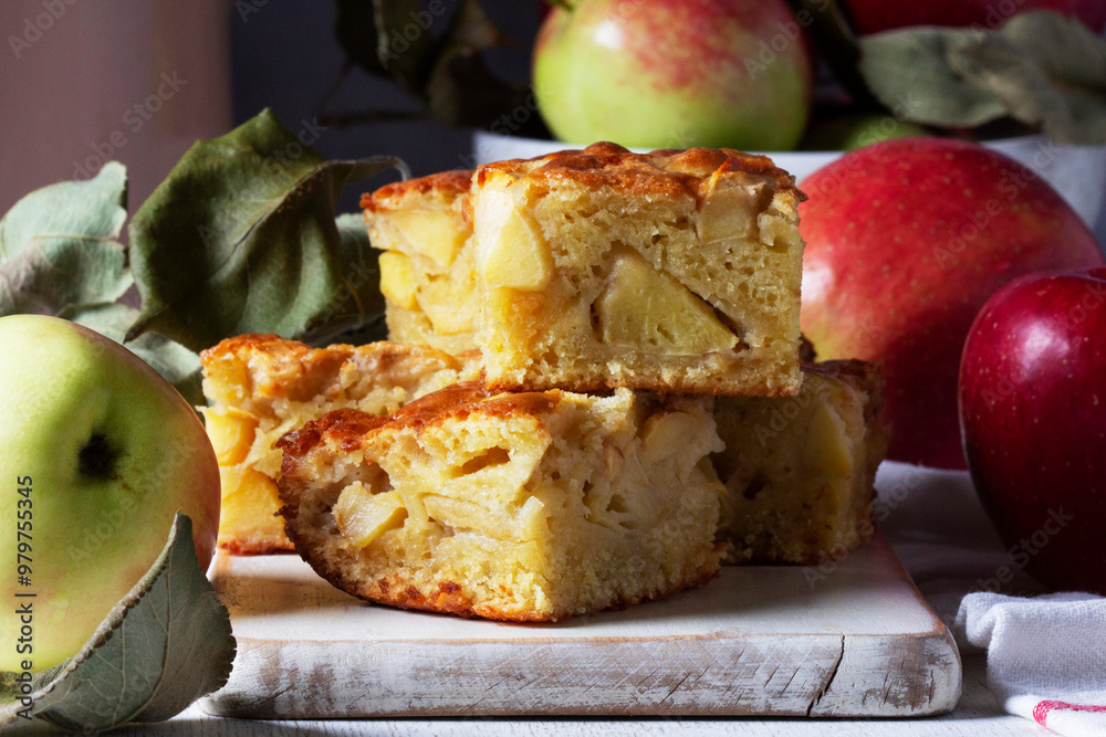 Apple pie, apples and teapot served for tea. Traditional apple dessert.
