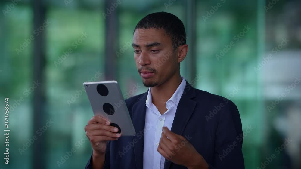 A professional man is actively using a tablet in a contemporary office environment setting A professional man is actively using a tablet in a contemporary office environment setting