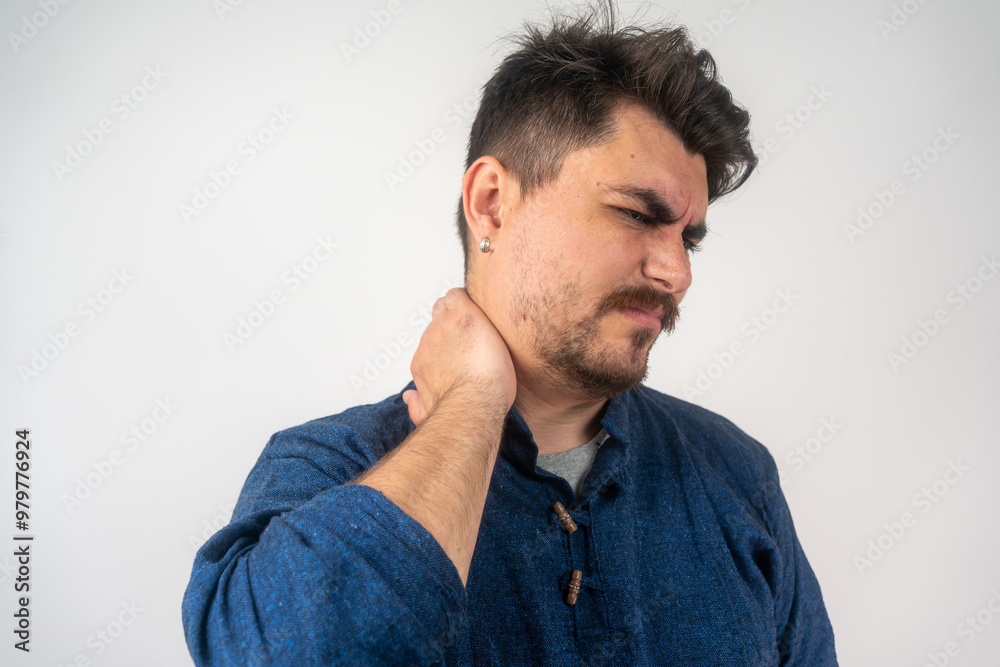 Fototapeta premium Young man suffering from neck pain. Headache pain. Young man suffering from neck pain on light background, side view