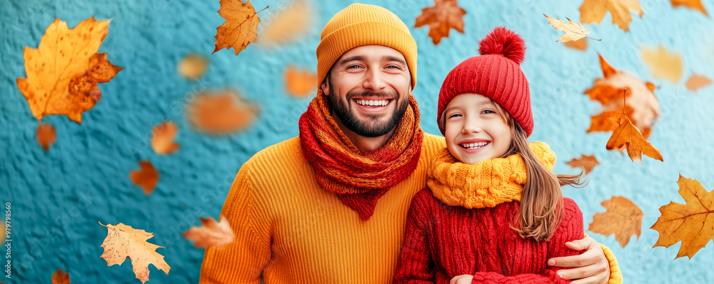 Fototapeta premium Woman playing with her child under the falling autumnal leaves, Family weekend concept.