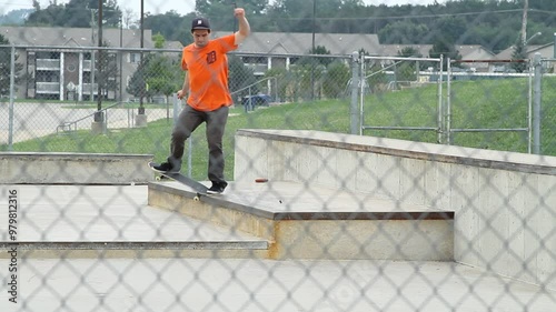 Middle age man exercising by practicing a skateboard trick at an outdoor local skate park apart of a healthy lifestyle 04