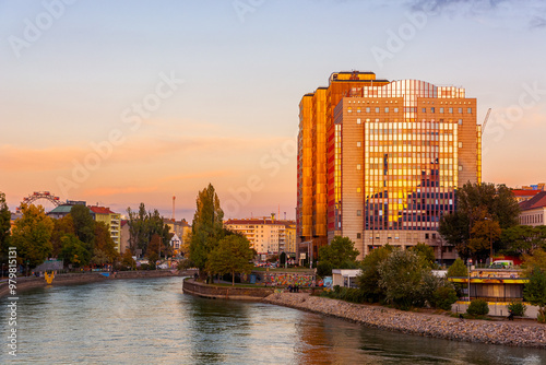 vienna, austria - 17 oct 2019: embankment of donaukanal in autumn. beautiful architecture and trees in fall season at sunset. urban scenery near aspernbrucke in evening light