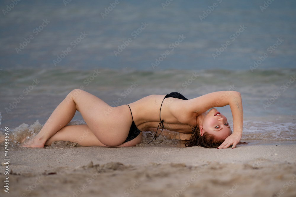 Sexy bikini body woman on paradise tropical beach splashing in sea water. Beautiful fit body girl on luxury summer travel vacation. Sensual woman in bikini lying on sandy summer beach. Sexy bikini body woman on paradise tropical beach splashing in sea water. Beautiful fit body girl on luxury summer travel vacation. Sensual woman in bikini lying on sandy summer beach.