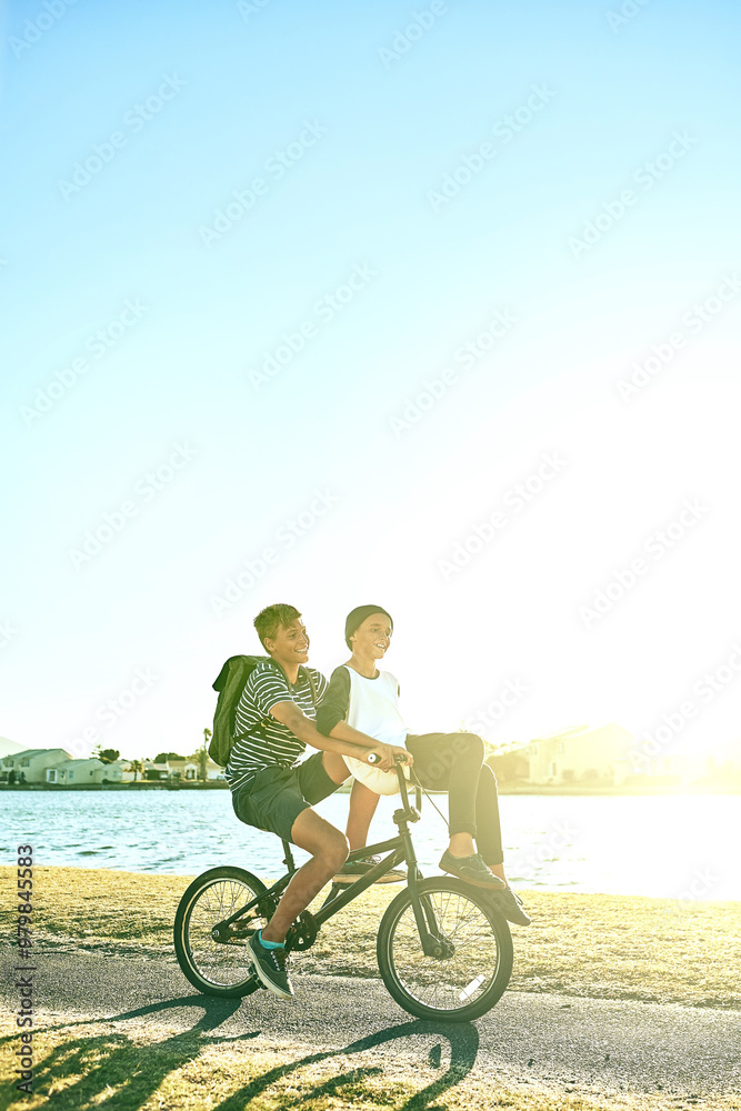 Obraz premium Nature, travel and siblings with bicycle for riding, paddle and coordination with balance for brothers. Lake, children and boys with bike for transport, speed and outdoor for bonding together
