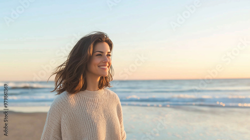 beautiful woman strolling along a beach in autumn. She should be wearing a light sweater that flutters in the gentle sea breeze. The scene should capture the soft morning light ref