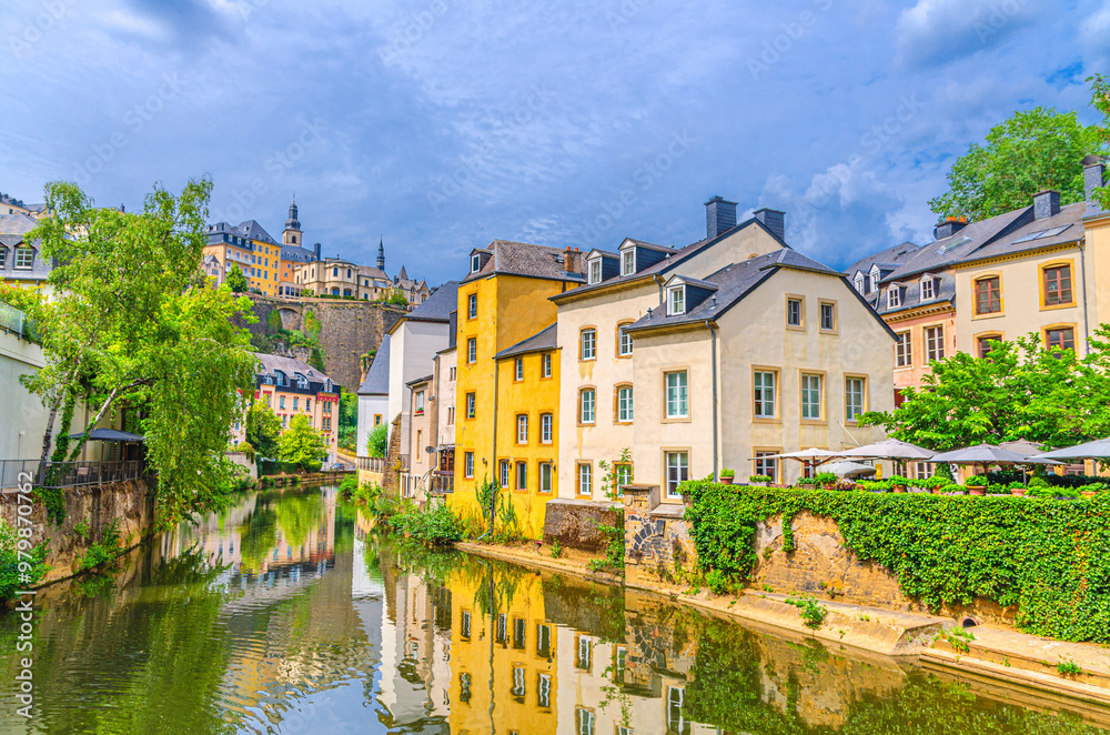 Grund quarter in Luxembourg City historical centre with old typical colorful buildings, green trees on bank of Alzette river valley in old town Gronn lower city and Ville Haute quarter background Grund quarter in Luxembourg City historical centre with old typical colorful buildings, green trees on bank of Alzette river valley in old town Gronn lower city and Ville Haute quarter background