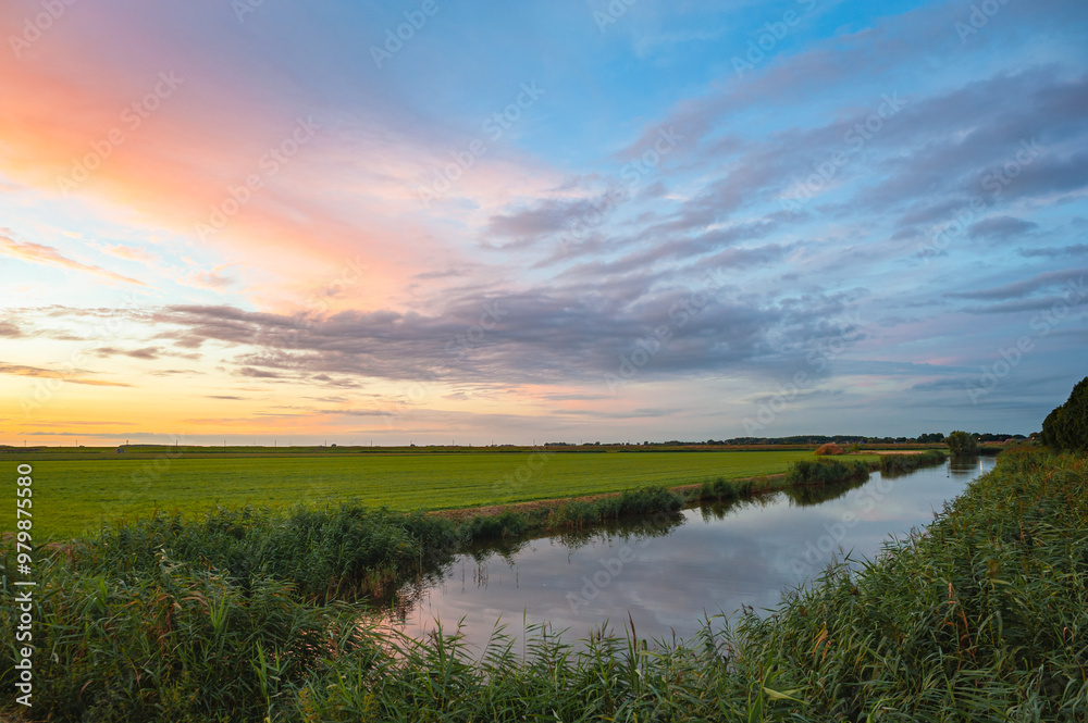 Colorful clouds in the evening over the Green Heart of Holland, a still open area between the cities of Amsterdam, Rotterdam, The Hague and Utrecht, The Netherlands. Colorful clouds in the evening over the Green Heart of Holland, a still open area between the cities of Amsterdam, Rotterdam, The Hague and Utrecht, The Netherlands.