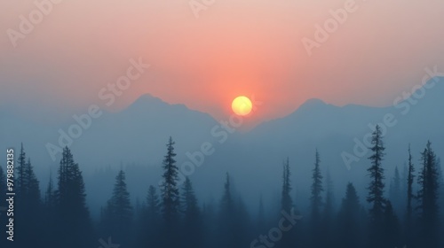 As the sun sets behind the mountain range, a soft orange hue blankets the sky while mist weaves through tall evergreen trees, creating a peaceful atmosphere at dusk in nature.