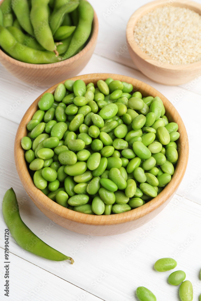 Fresh edamame soybeans, pods and seeds on white wooden table, above view Fresh edamame soybeans, pods and seeds on white wooden table, above view
