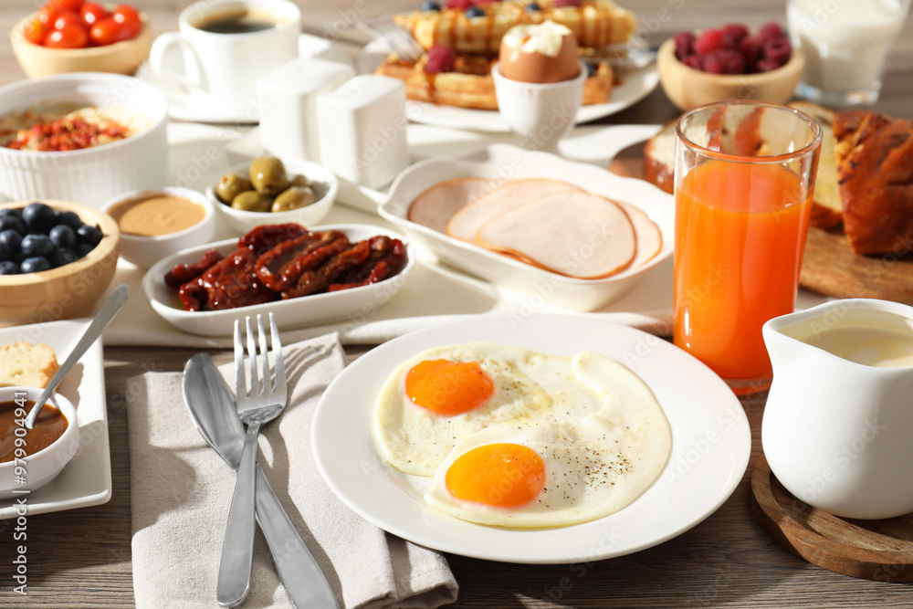 Different meals served for breakfast on wooden table Different meals served for breakfast on wooden table