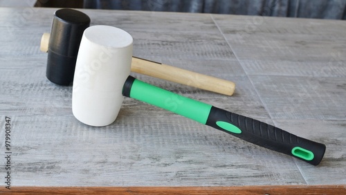 Two rubber hammer on the table.