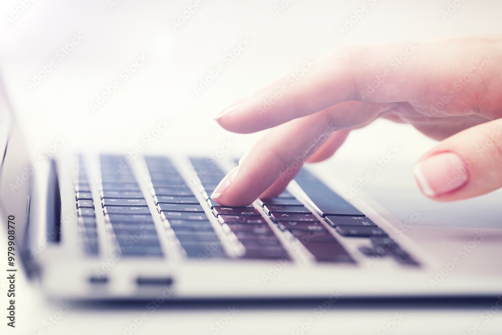 A man typing on a laptop computer keyboard A man typing on a laptop computer keyboard