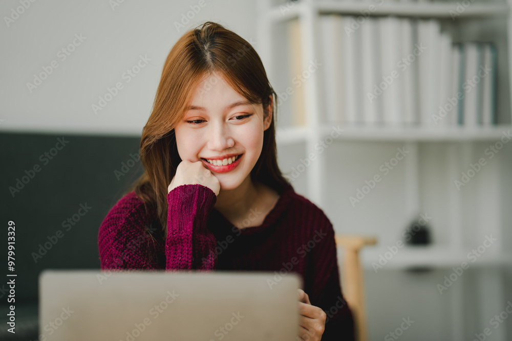 Smiling young woman uses social media to relax at home on the weekend. Relaxation concept Smiling young woman uses social media to relax at home on the weekend. Relaxation concept