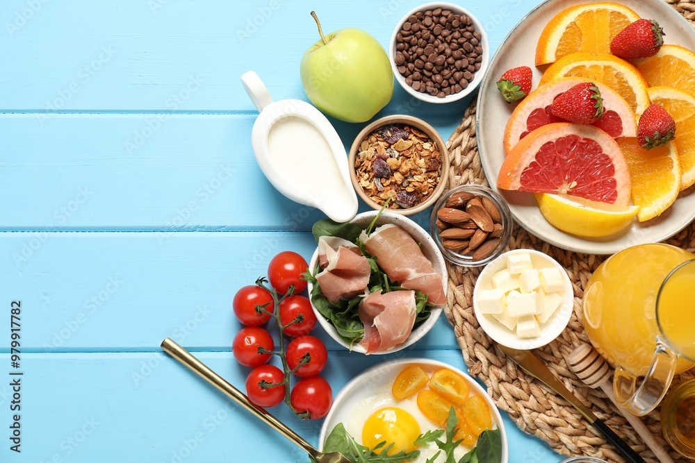 Different tasty food served for brunch on light blue wooden table, flat lay. Space for text Different tasty food served for brunch on light blue wooden table, flat lay. Space for text