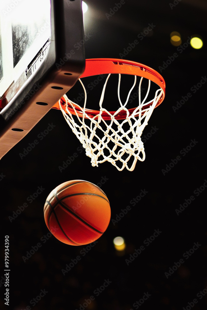 Fototapeta premium Vertical poster with a basketball flying into a basket, advertising a competition or an invitation to a game, concept of popularizing sports, and promotion of sports grounds in city squares