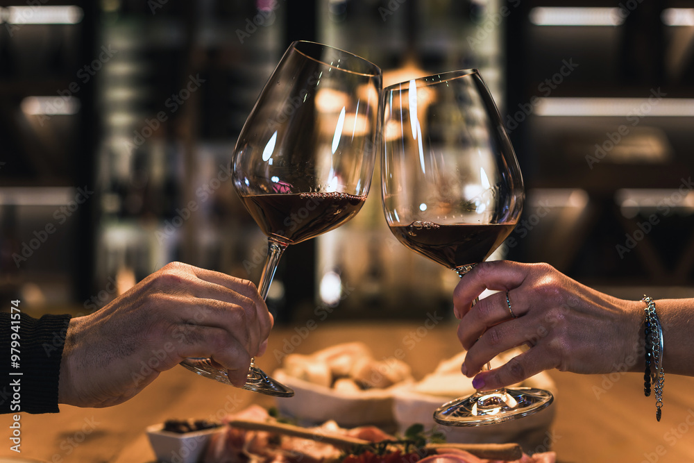Smiling couple dining in a wine cellar room, enjoying fine white wine and delicious food Smiling couple dining in a wine cellar room, enjoying fine white wine and delicious food