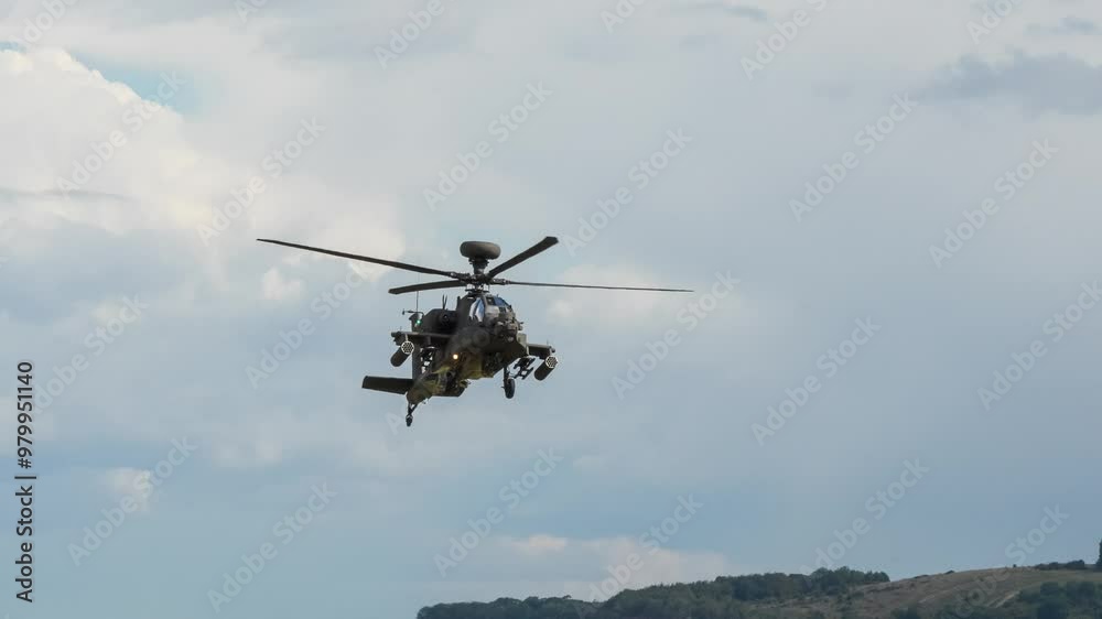 British army Boeing Apache Attack helicopter AH64E (AH-64E ArmyAir606) AH2 pulls up to a stationary hover and then hovers to port. British army Boeing Apache Attack helicopter AH64E (AH-64E ArmyAir606) AH2 pulls up to a stationary hover and then hovers to port.