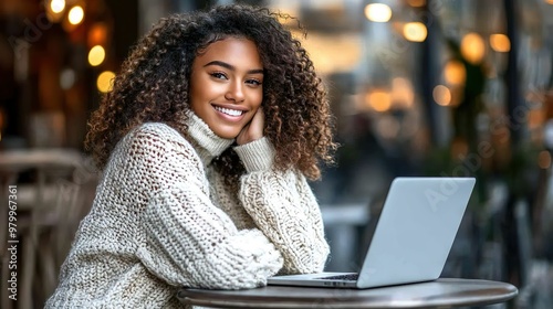 Happy African American Woman Working On Laptop In Cozy Cafe With Bright Lighting