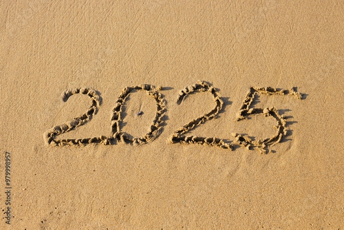 2025 number on a sand beach. Abstract background photo of coming New Year 2025.