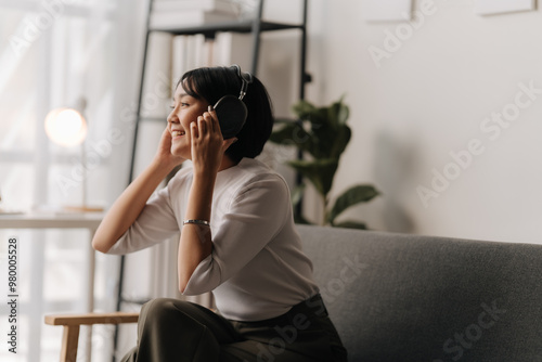 Lost in the Melody: A young woman finds peace and serenity in the soothing sounds of her headphones, lost in a world of music and relaxation. The image captures the intimate moment of self-care and pe