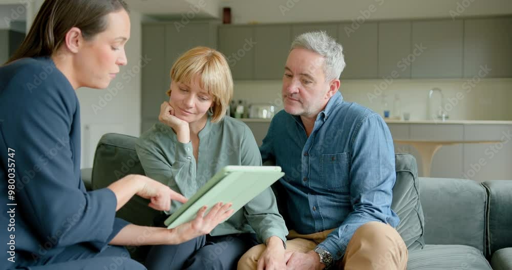 Mature Couple Meeting with a Financial advisor in their Home, looking at Digital tablet Mature Couple Meeting with a Financial advisor in their Home, looking at Digital tablet