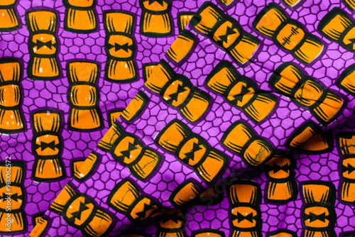 top view of purple ankara fabric, flatlay of nigerian wax cloth, rumpled purple ankara material photo