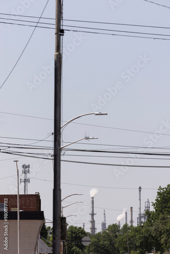 Oil refinning smoke stacks spew  global warming carbon dioxide near downtown Ponca City, Oklahoma, USA. photo