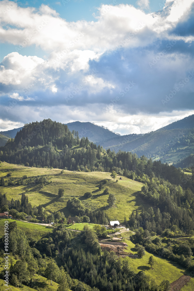 Fototapeta premium Nature's Canvas: Hills and Mountains Beneath a Cloudy Sky