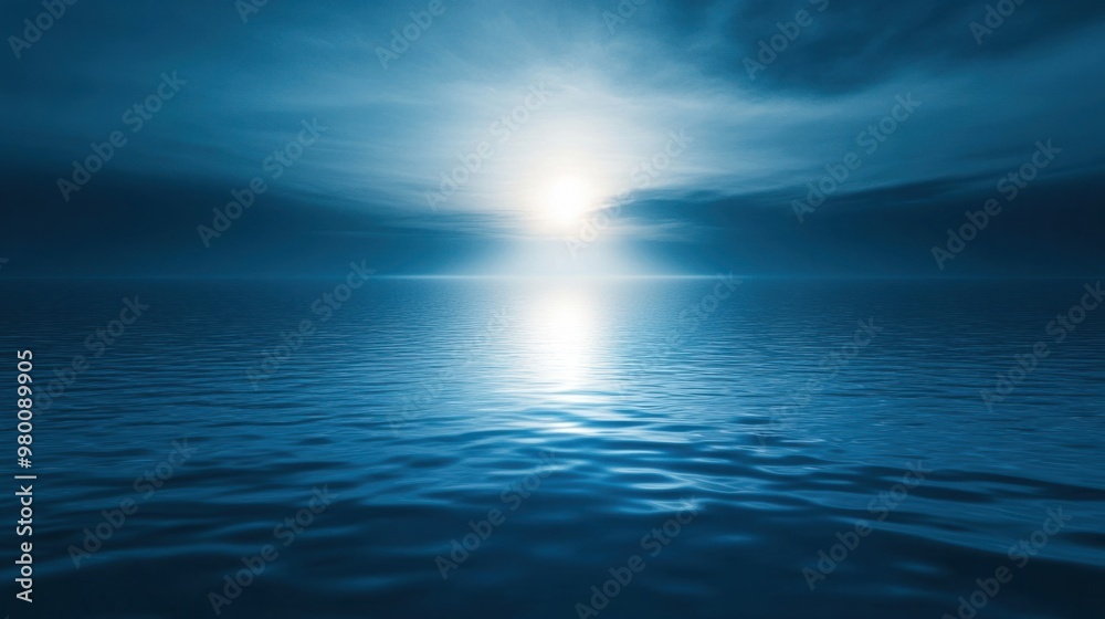 Obraz premium A beam of soft blue light casting a glowing reflection on water, creating a serene and peaceful atmosphere.