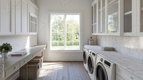 Laundry room in new custom built luxury home. Features sink, desk, and quartz counters and backsplash.