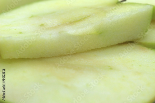 sliced green apple. apple slices. apple background. close up on apple. one slice on top of another.