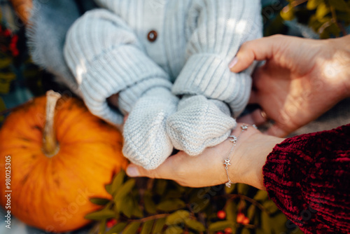 Children's feet in hands of mother. Mother and Child. Happy Family concept. Beautiful conceptual image of Motherhood