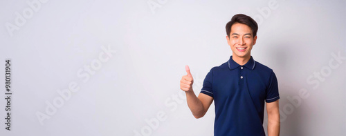 A portrait of a smiling Asian man wearing a navy blue polo shirt.